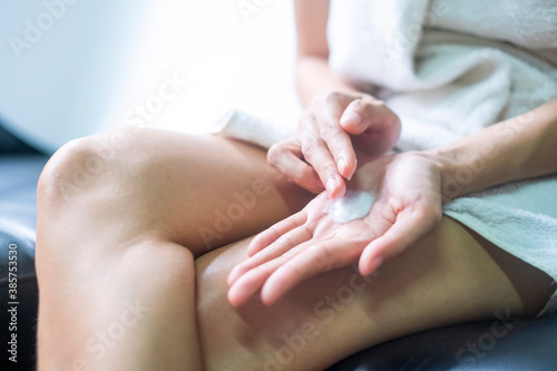 Asia woman applying moisturizing cream lotion on hands  beauty concept.