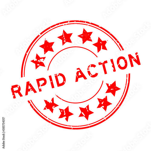Grunge red rapid action word with star icon round rubber seal stamp on white background