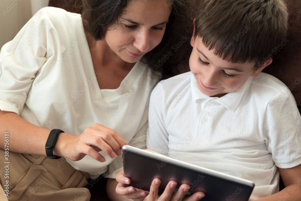 Mother with boy using digital tablet. Education technology. Soft focus Mother with boy using digital tablet. Education technology. Soft focus