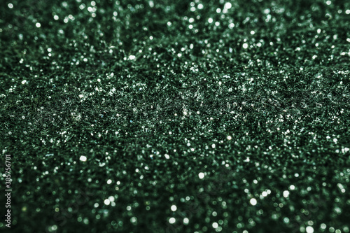 Green glitter texture sparkling shiny wrapping paper background for Christmas holiday decoration, greeting and wedding invitation card design element, Xmas abstract background with copy space