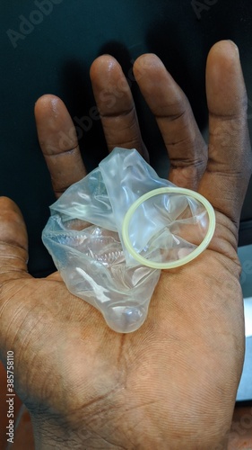 hand holding a condom