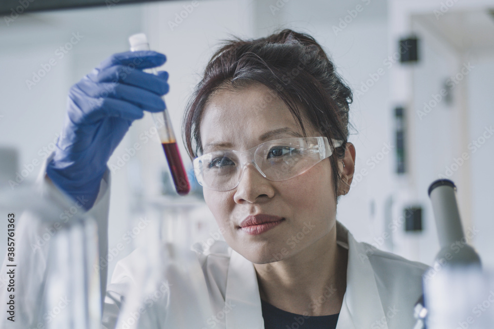 © ReeldealHD images - Female scientist studying a sample in a test tube
