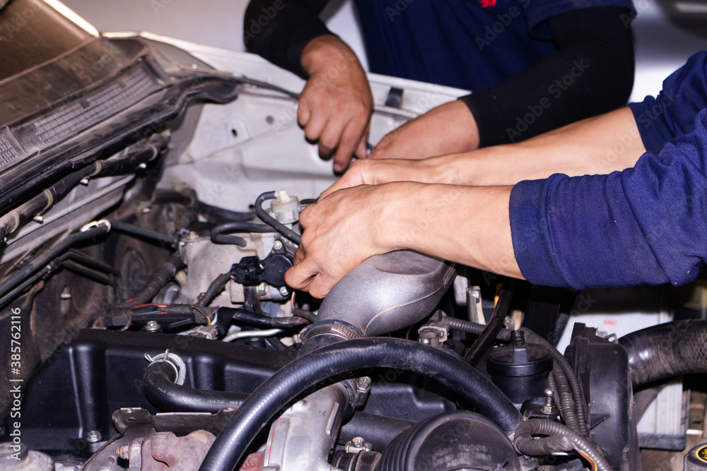 The mechanic is checking the engine. The mechanic is checking the engine.