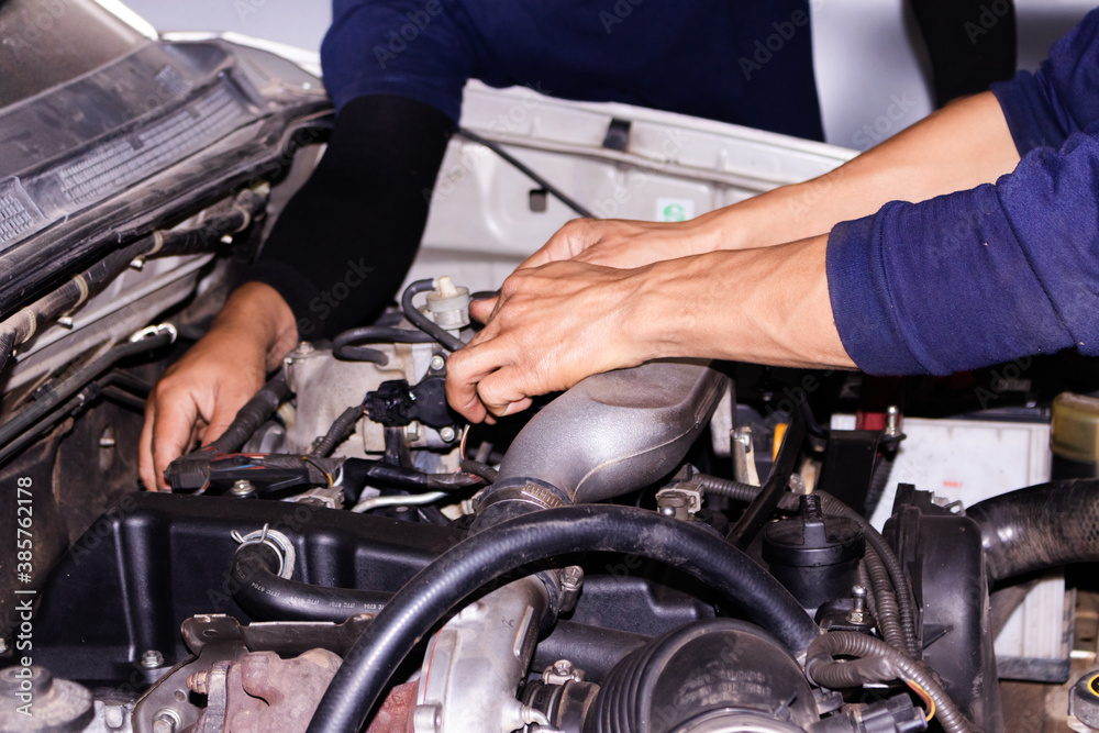 The mechanic is checking the engine. The mechanic is checking the engine.