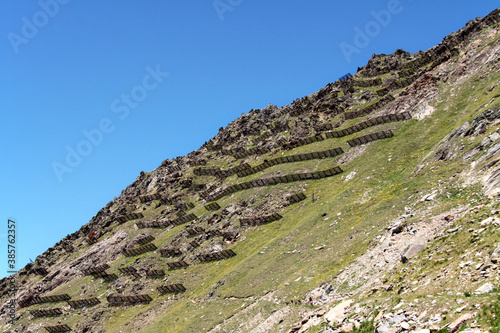 Canvas Print Avalanche protection on a steap mountain  slope