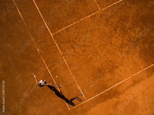Female tennis player on the court. Wide angle view from above with plenty of copyspace