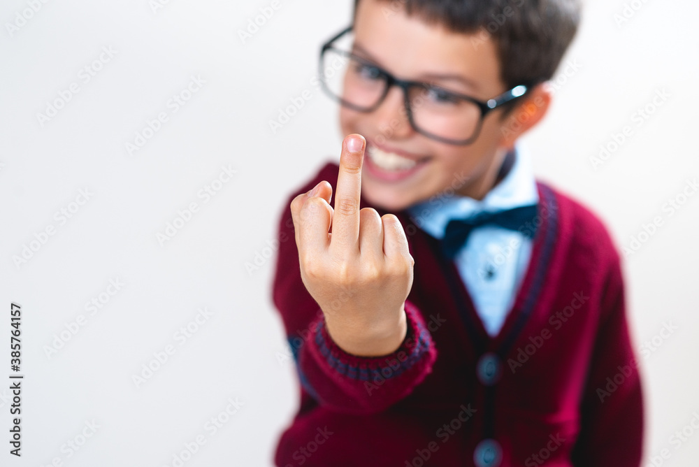 Schoolboy in a sweater shows a finger to the camera. Conceptual. Copy space.