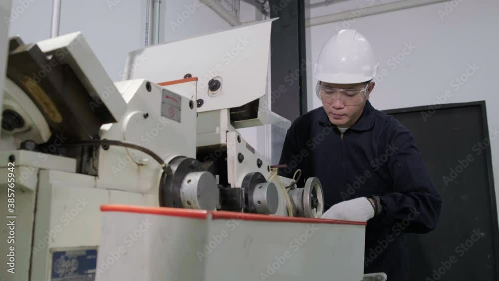 An Asian male engineer is inspecting and repairing machines in the factory. Engineering and industrial concept. An Asian male engineer is inspecting and repairing machines in the factory. Engineering and industrial concept.
