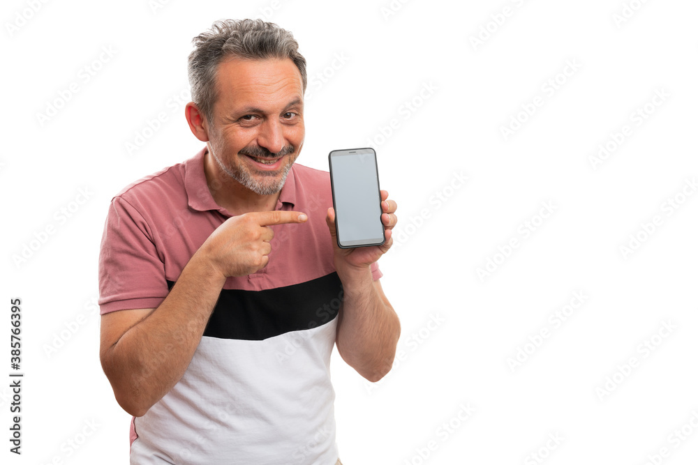 Friendly man pointing index finger at smartphone with copyspace Friendly man pointing index finger at smartphone with copyspace