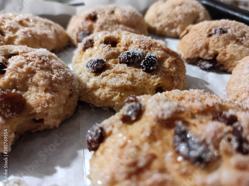 Homemade cottage cheese cookies with raisins sprinkled with sugar close-up.