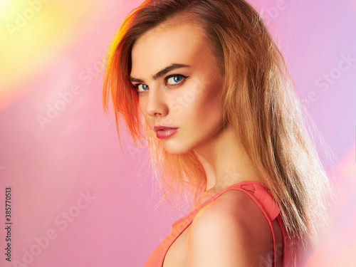 Beautiful girl with makeup in colorful lights