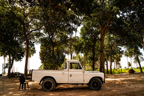 September 25, 2020: Pulau Redang Terengganu, Malaysia: White Land Rover Defender under the tree beside the sea