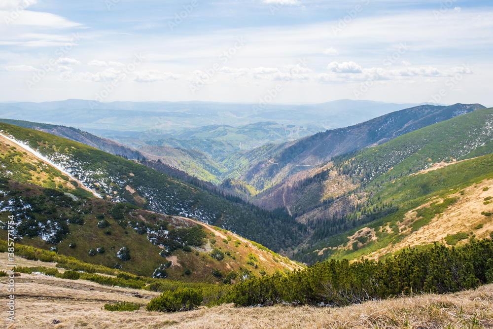 Fototapeta premium Views from Dumbier Mountain in Low Tatras mountains. Late spring, snow-capped mountains. Tourism and hiking NAPANT National Park travel destination