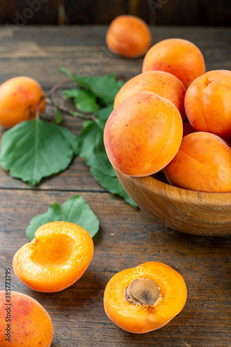 Delicious ripe apricots in a wooden bowl