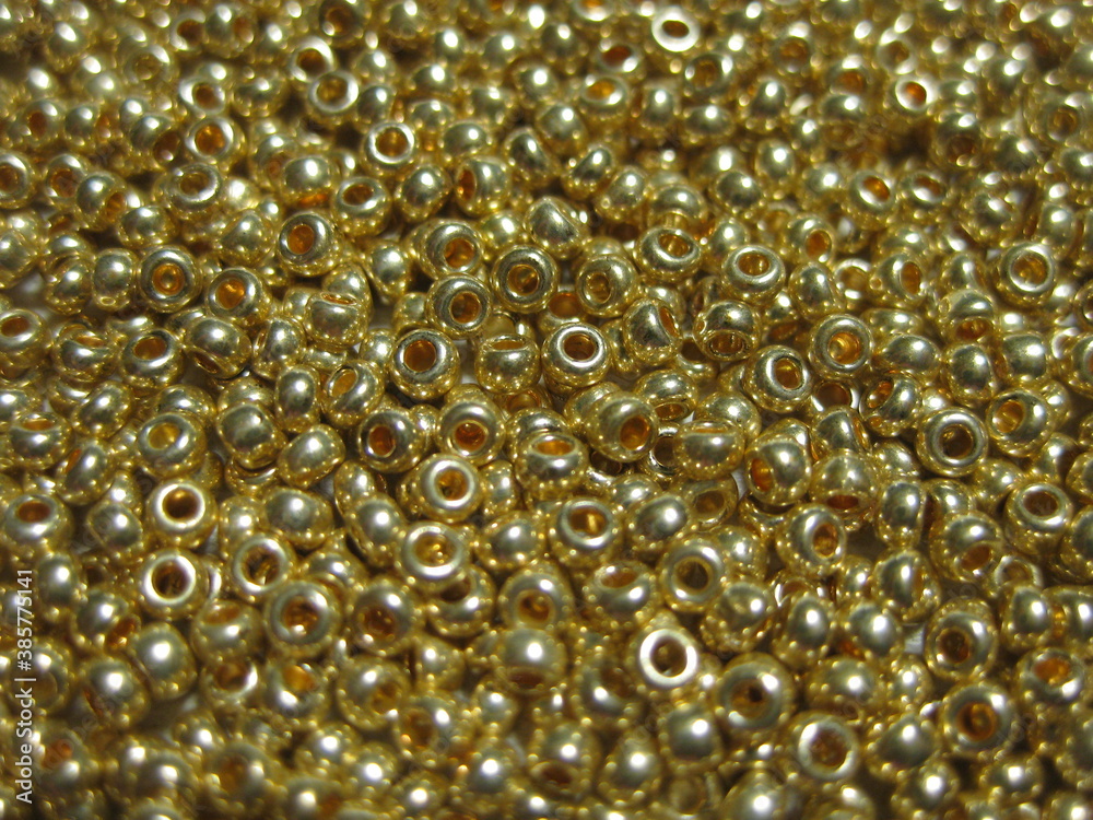 Golden glossy beads close-up. Golden glossy beads close-up.
