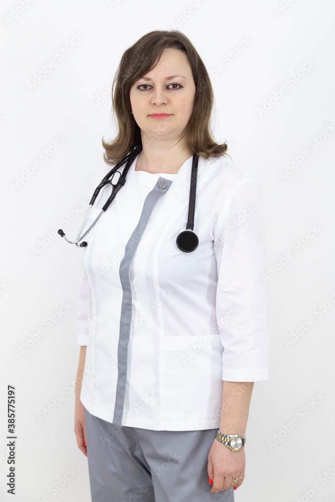 adult female doctor with a stethoscope against a white wall. adult female doctor with a stethoscope against a white wall.