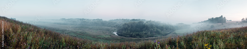 Panoramic view of foggy hills
