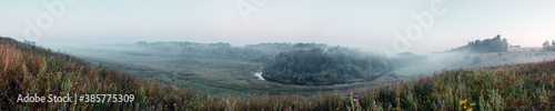 Panoramic view of foggy hills