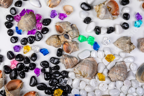 Bright background of their colored stones and seashells.