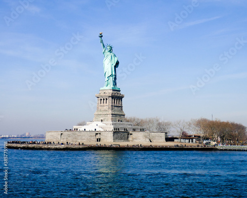 Statue of Liberty in NY Harbor on bright sunny day with blue sky © Gerald Zaffuts