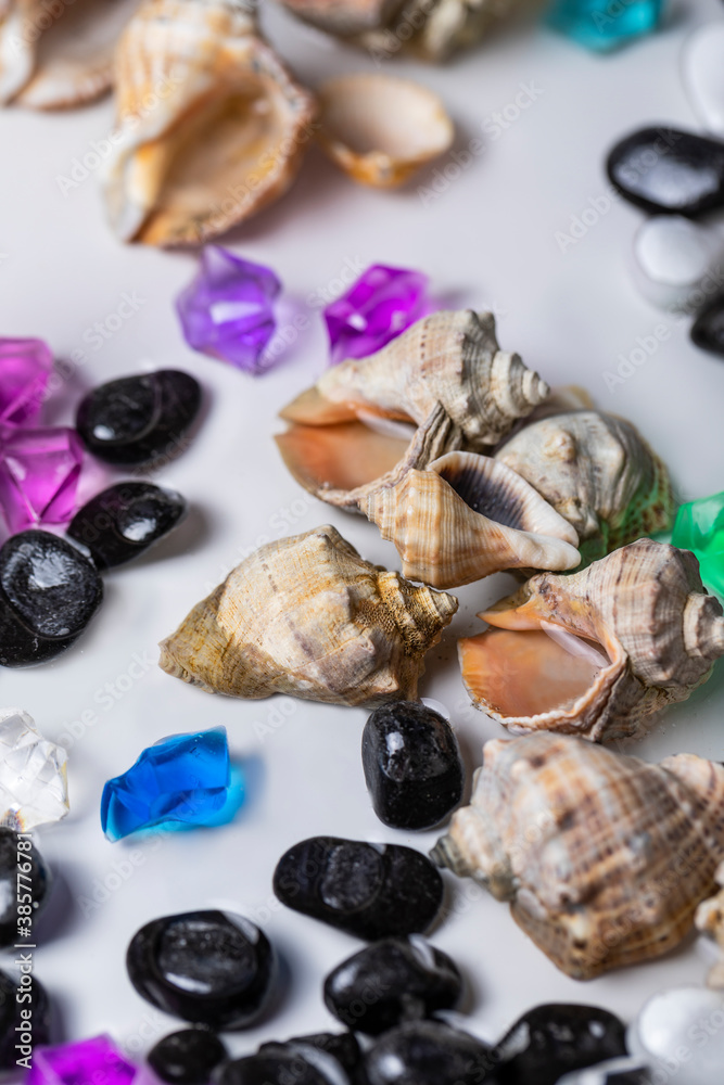 Bright background of their colored stones and seashells.