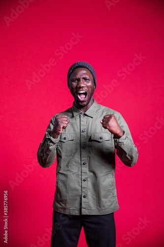 Young Black Man Shouting on Isolated Background