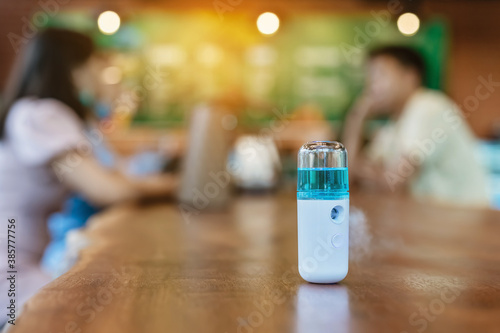 Wallpaper Mural Alcohol nano mist sprayer for hand cleaning to prevent the spread of the Corona virus (Covid-19) to serve customers at coffee shop. Modern health technology. New normal lifestyle. Selective focus Torontodigital.ca