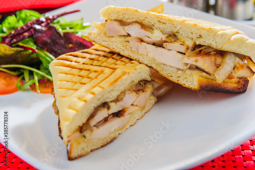 Toasts with roasted beef served with french fries and salad photo