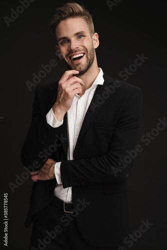 Happy confident unshaven businessman laughing at camera