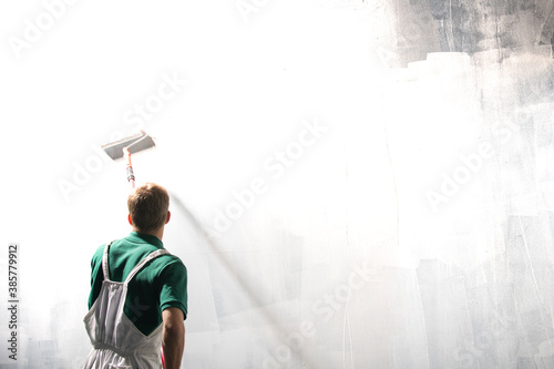 Male decorator painting a wall