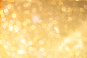 Gold light shiny bokeh abstract blur background with bright round defocus golden pattern, can use for Christmas festive decoration and design