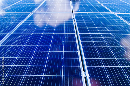 Solar energy panel power system, view up on and sky with clouds