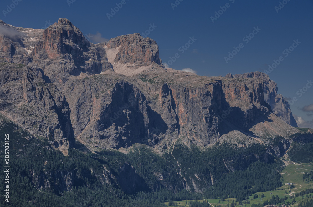 View of the north side of Sella mountain group, plateau-shaped massif with Gardena pass in background, from Piz La Ila mountain, Val Badia, La Villa village, Dolomites, Alta Badia, South Tirol, Italy.