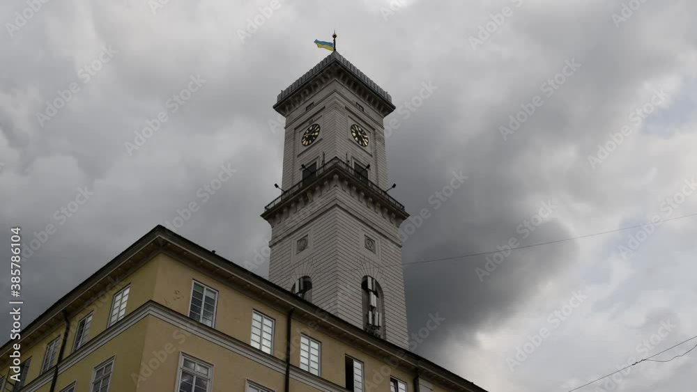 Time lapse of moving stormy clouds over ancient Town Hall in European city. Architecture in Viennese Classical style. Lviv town hall clock tower located at Market Square Time lapse of moving stormy clouds over ancient Town Hall in European city. Architecture in Viennese Classical style. Lviv town hall clock tower located at Market Square