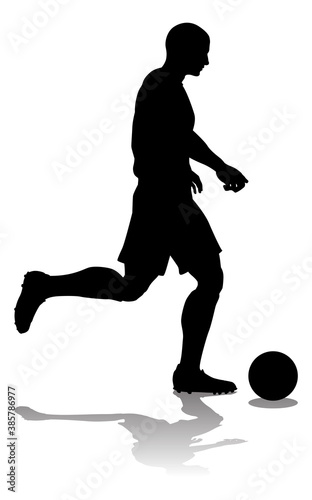 A soccer or football player in silhouette
