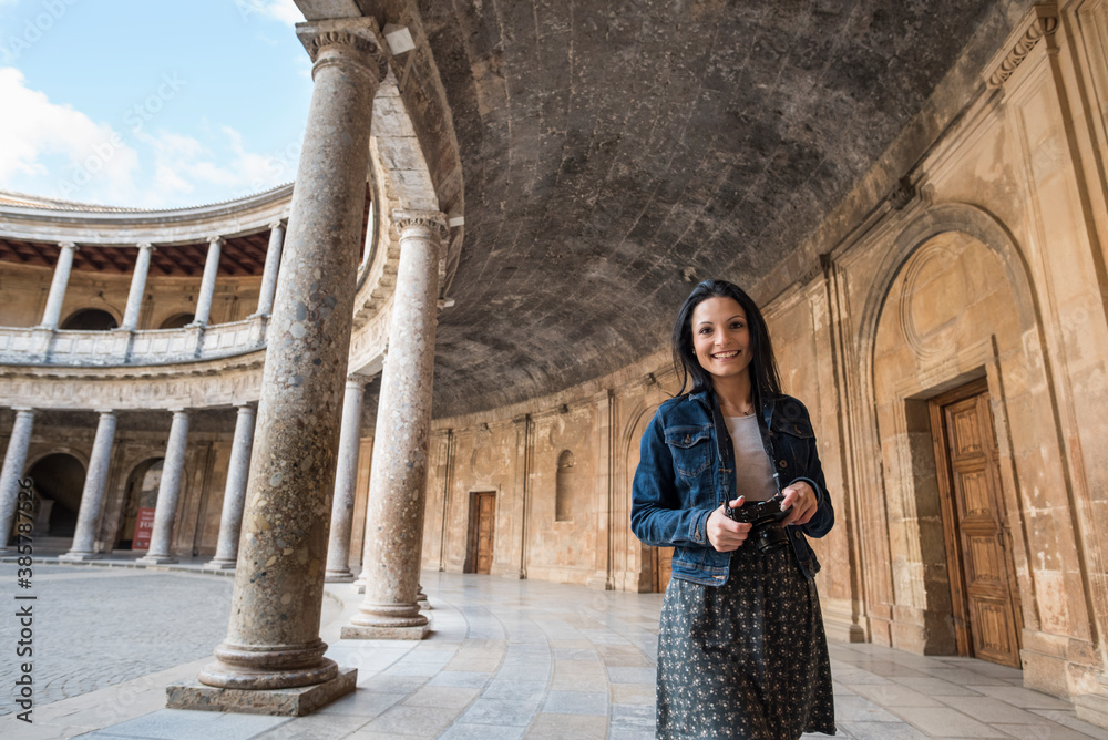 Tourist young woman in Carlos V palace, in 