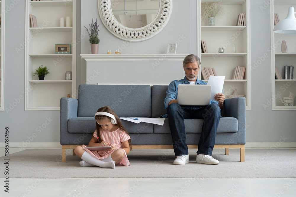 Father and daughter using electronic devices at home Father and daughter using electronic devices at home