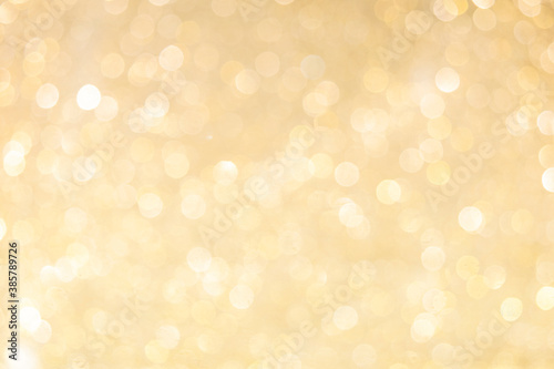 Gold light shiny bokeh abstract blur background with bright round defocus golden pattern, can use for Christmas festive decoration and design