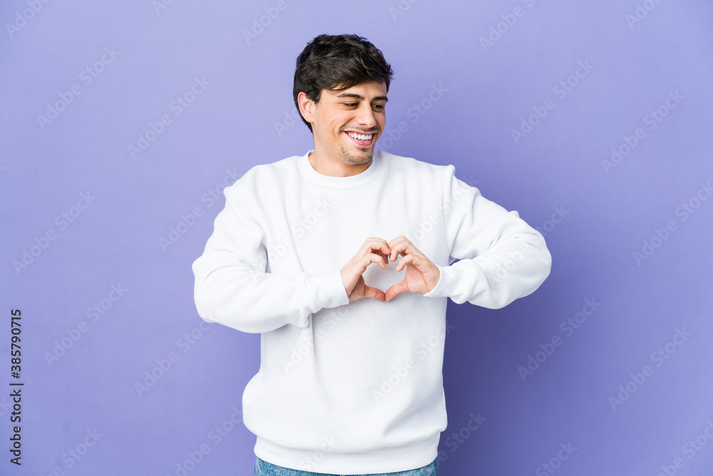Young cool man smiling and showing a heart shape with hands. Young cool man smiling and showing a heart shape with hands.