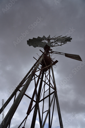 A windmill against ominous grey  clouds in the Karoo in South Africa