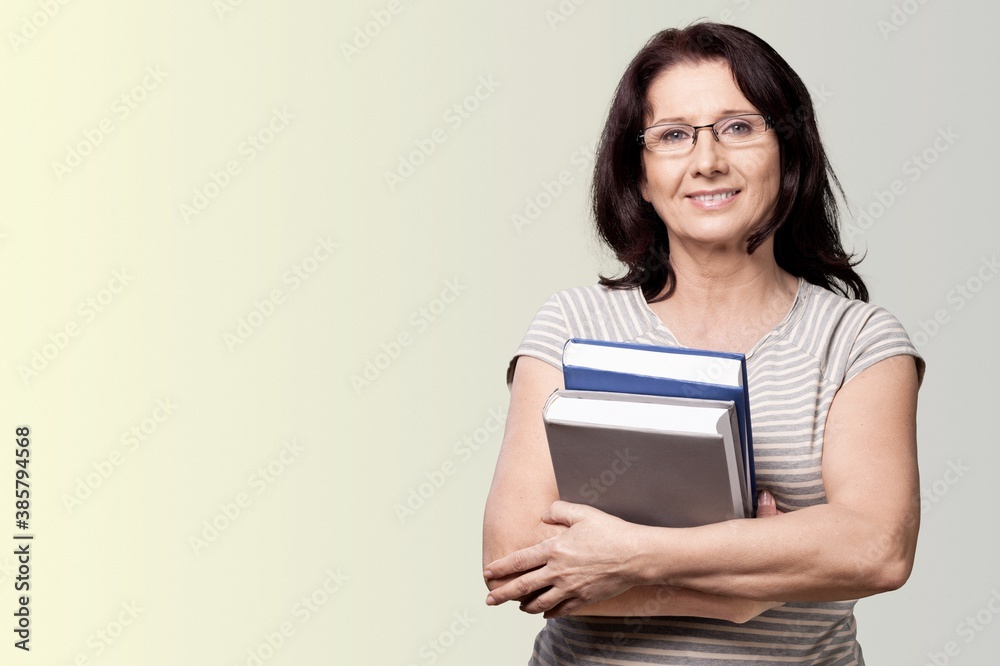 Smile woman teacher with books on background Smile woman teacher with books on background
