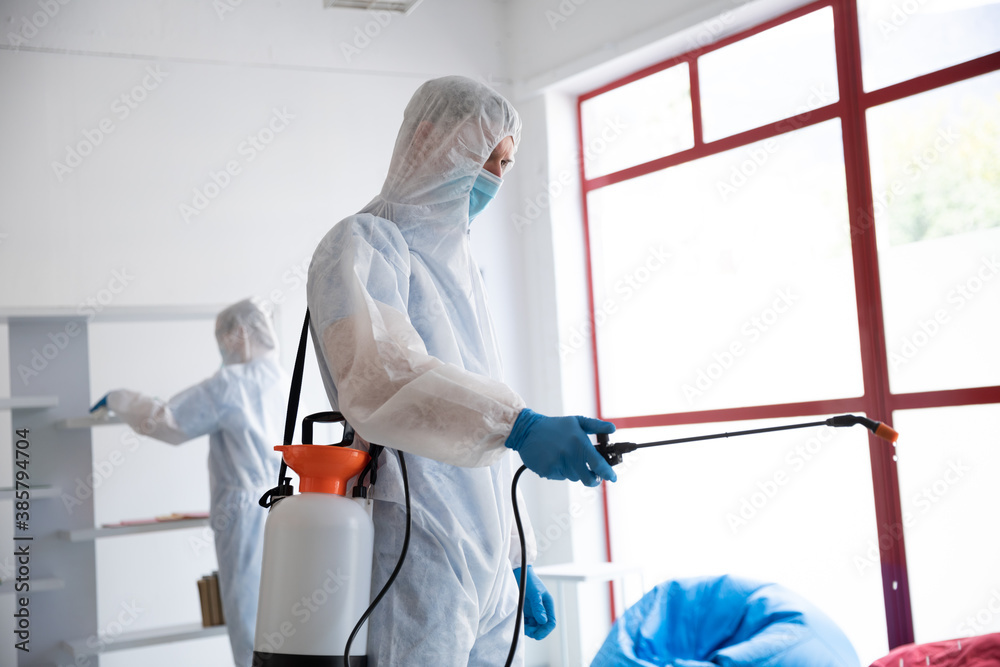 Health worker wearing protective clothes cleaning using disinfectant
