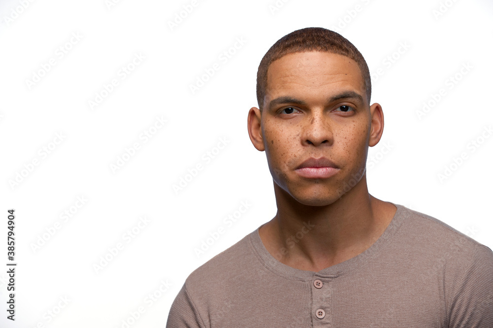 Portrait of young black man looking at camera with straight face Stock Photo | Adobe Stock