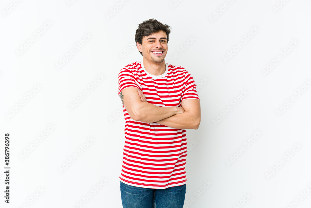 Young cool man who feels confident, crossing arms with determination. Young cool man who feels confident, crossing arms with determination.