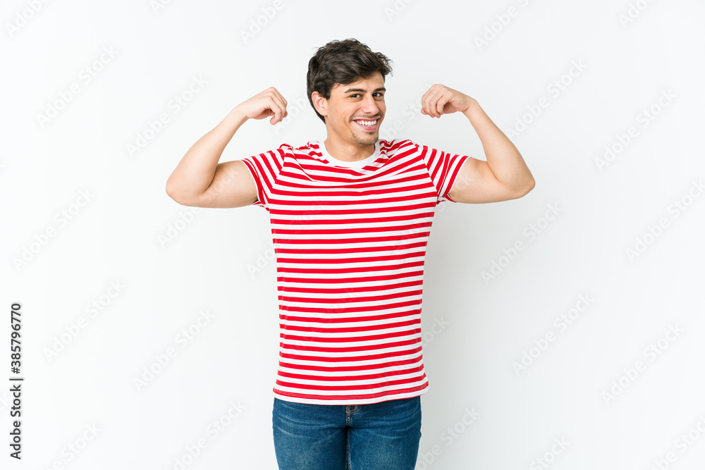 Young cool man showing strength gesture with arms, symbol of feminine power Young cool man showing strength gesture with arms, symbol of feminine power