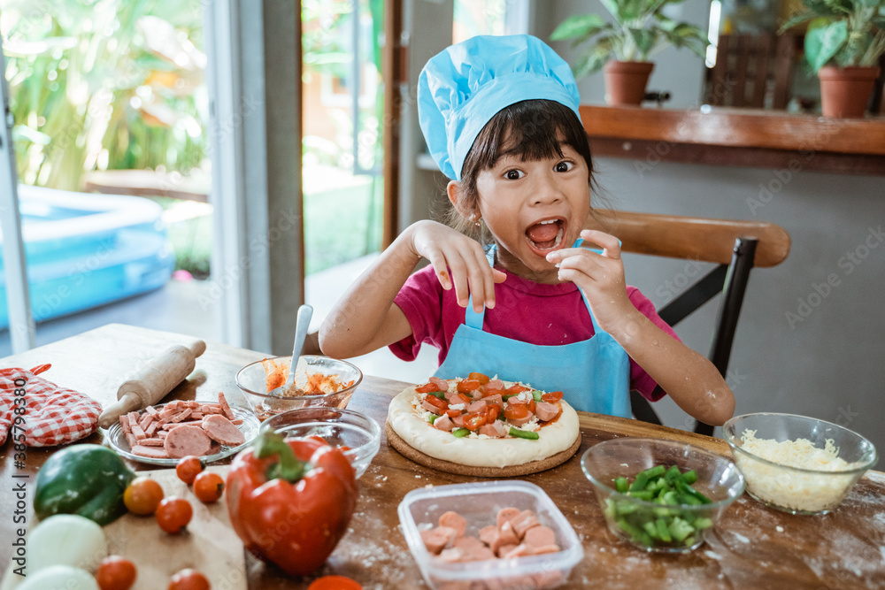 Little child girl eating pizza slices as symbol of best food after make it Little child girl eating pizza slices as symbol of best food after make it