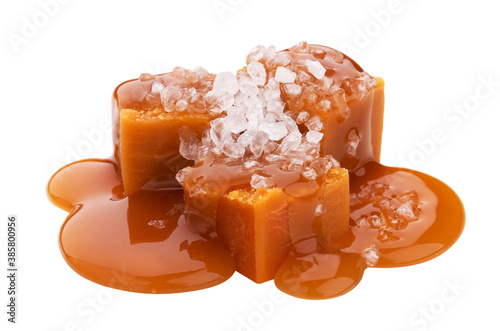 Toffee candies with caramel sauce and salt isolated on white background photo