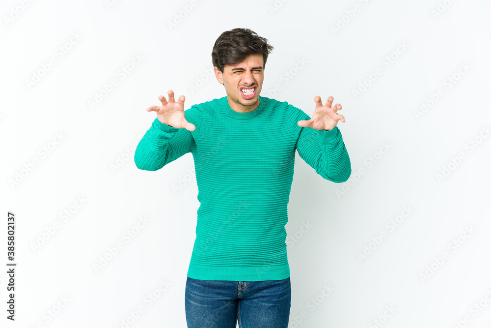 Young cool man showing claws imitating a cat, aggressive gesture. Young cool man showing claws imitating a cat, aggressive gesture.