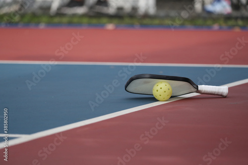 pickleball paddle with ball during a tournament