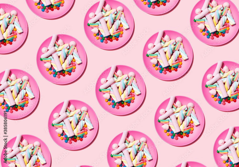 Pattern of plastic plates with marshmallows and candies Pattern of plastic plates with marshmallows and candies
